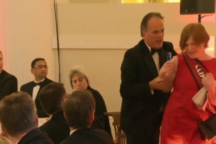 British minister suspended after grabbing climate change protester by the neck 